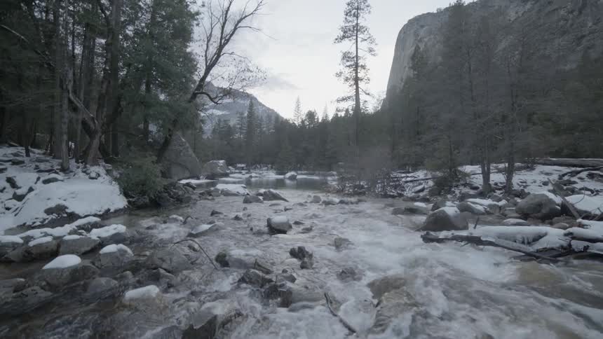 A rocky, snow lined river