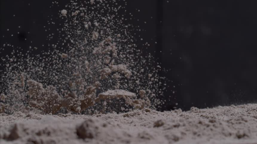 Sand explodes upwards and falls back