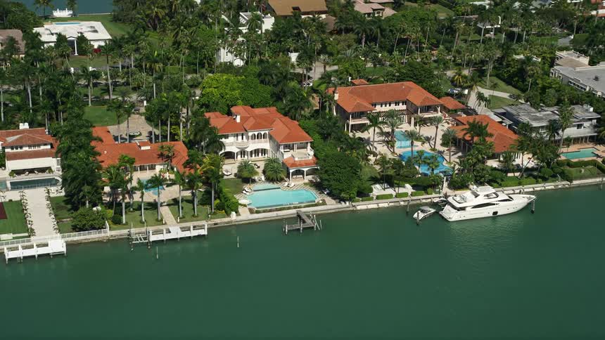 This aerial footage showcases luxurious mansions on the shores of Palm Island Florida