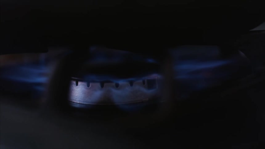 The flame on a gas burning igniting and glowing blue