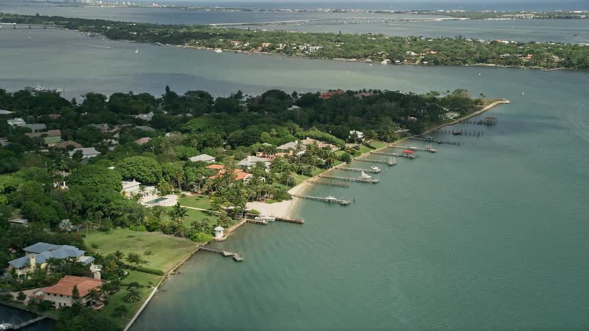 Aerial footage of a waterfront community and docks in Stuart Florida on a partly cloudy day
