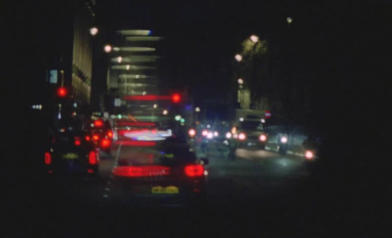Cars stop at traffic lights in a city road