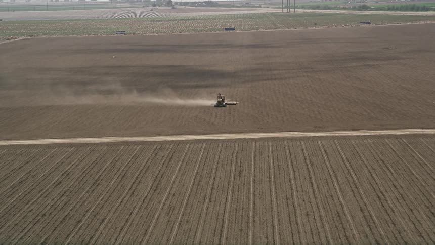 An aerial view of a tractor tilling a farm field in Camarillo California