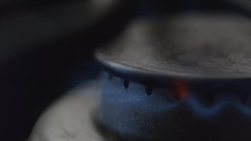 A burner on a stove with a flame