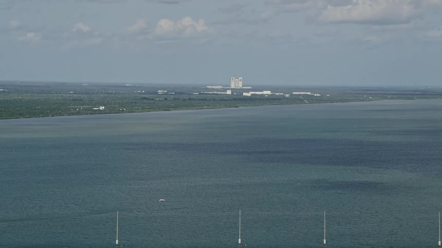 An aerial view of Cape Canaveral military base and NASA center across the Banana River in Florida during a partly cloudy day