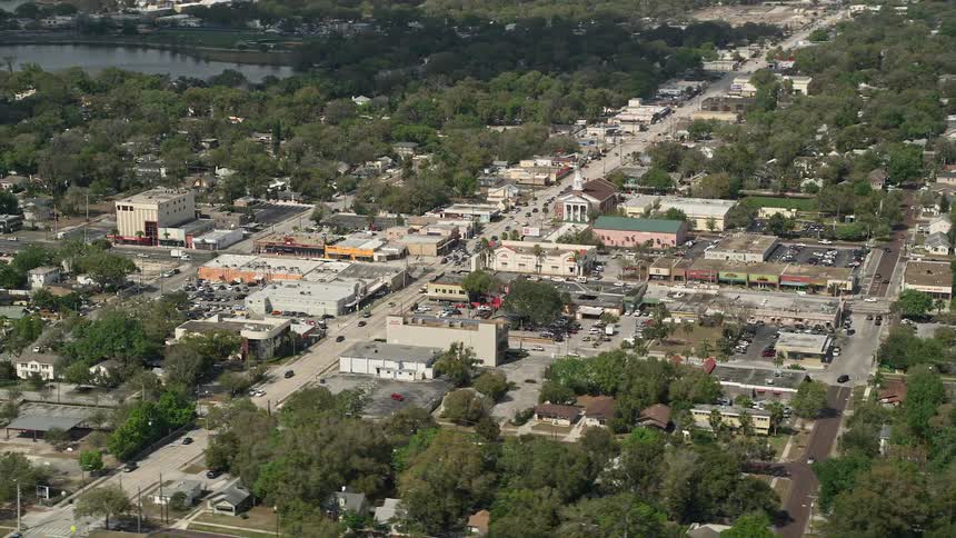 An aerial view of a small church and shops in a busy street in Orlando Florida during the daytime