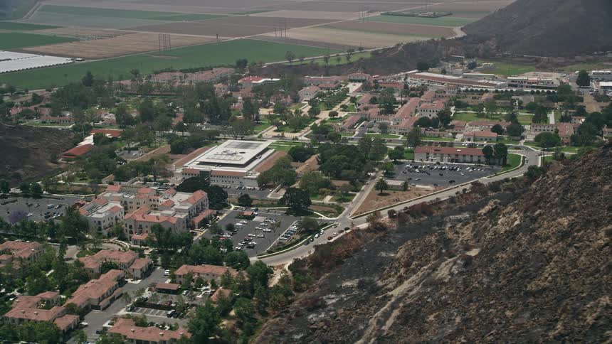 A sunny aerial flyby of California State University Channel Islands showcasing its picturesque campus and adjacent nature backdrop
