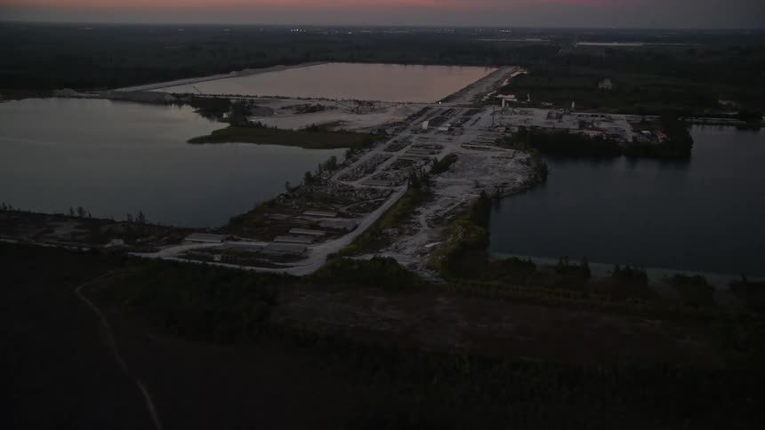 Approaching a quarry in Homestead Florida during twilight filmed from an aerial 