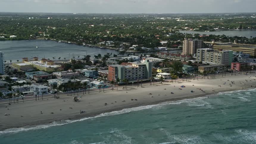 A birds-eye view of Hollywood Floridas lively beach with umbrellas apartment buildings and sunbathers soaking up the Florida sun