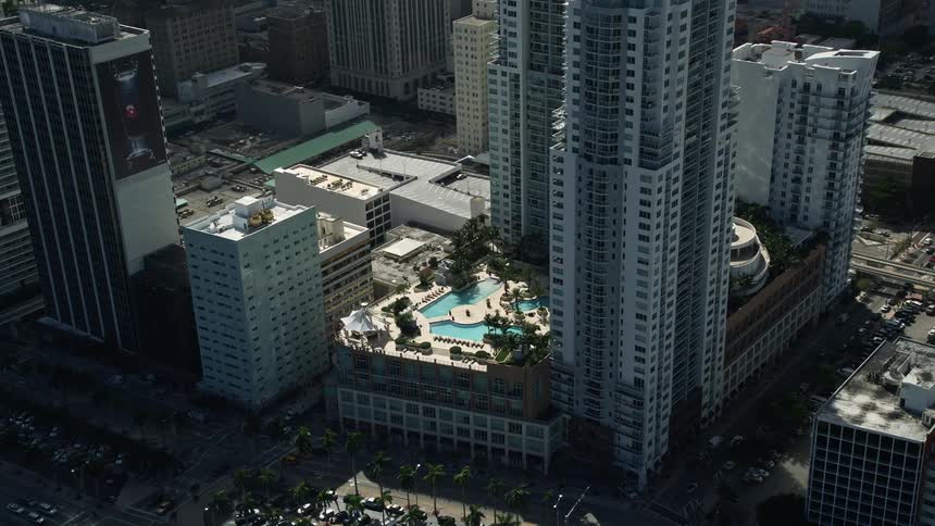 Approaching the North and South Tower of Vizcayne in Downtown Miami the aerial footage tilts down to showcase the rooftop pool with stunning views of the city