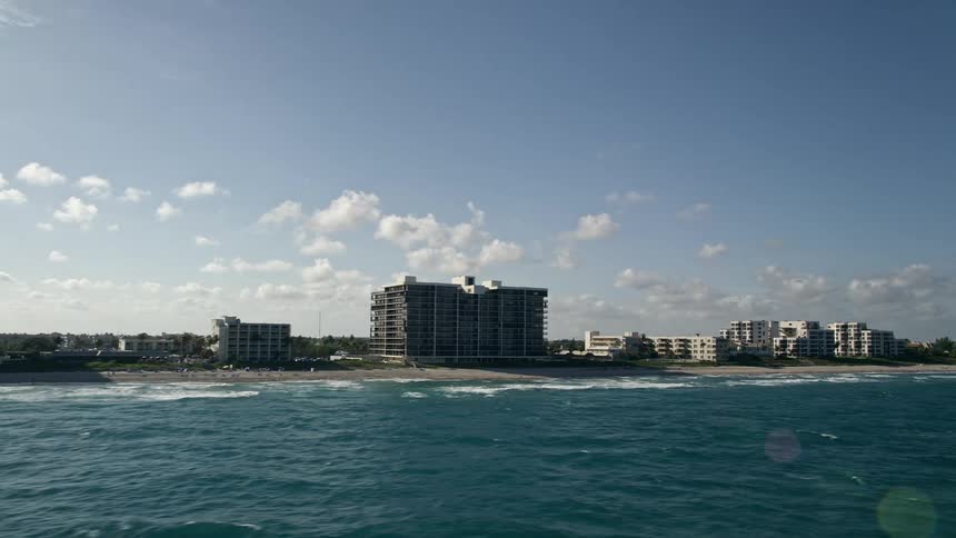 A breathtaking aerial view of condominiums and apartments by the beach in Highland Beach Florida on a beautiful summer day