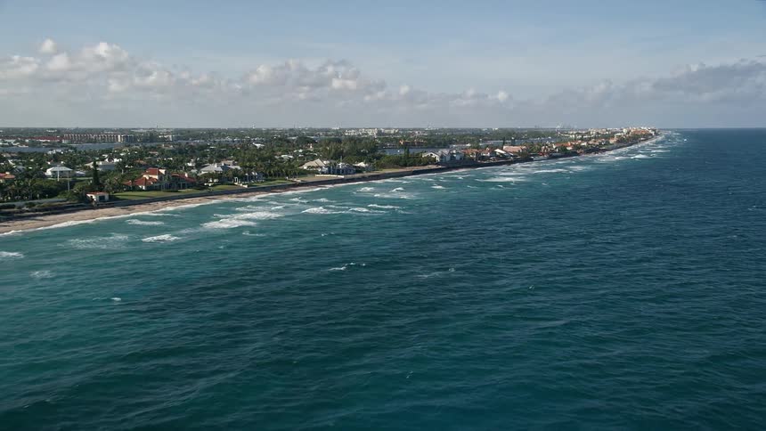 Aerial footage of coastal mansions in Manalapan Florida during daytime with partly cloudy skies