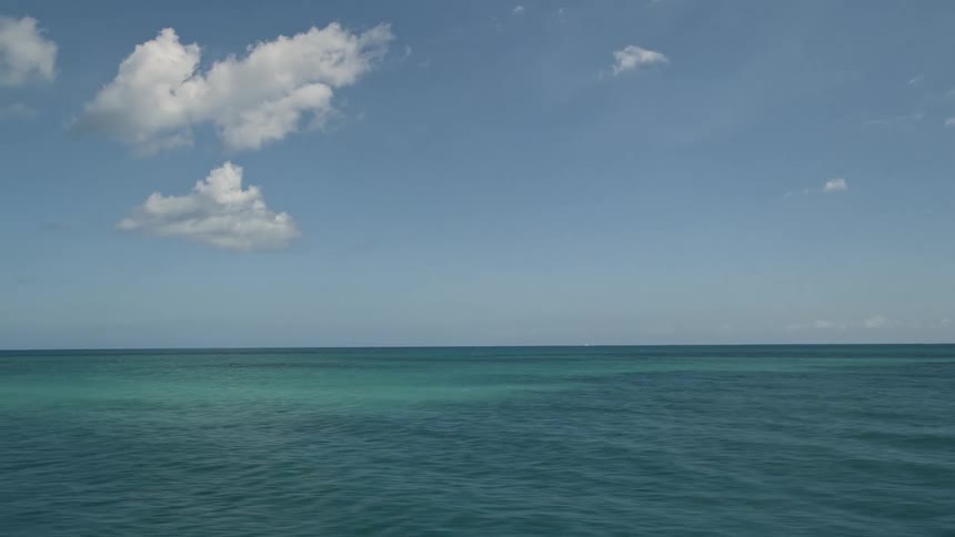 An aerial view of the Atlantic Ocean near Fort Pierce Florida with partly cloudy skies and calm clear waters for use as a VFX plate