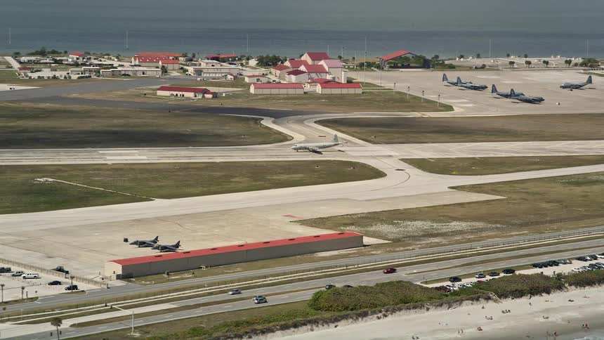 Military plane takes off from Patrick Air Force Base on a partly cloudy day