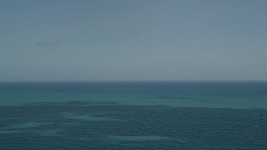 Aerial view of the blue ocean reaching out into the horizon from Vero Beach Florida on a partly cloudy day