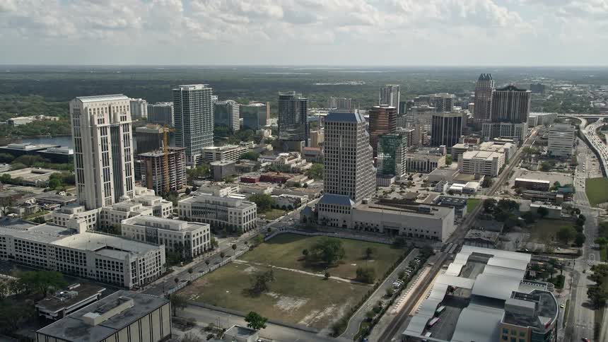 An aerial view of Downtown Orlando and Interstate 4 during the day showing the bustling city and its towering buildings