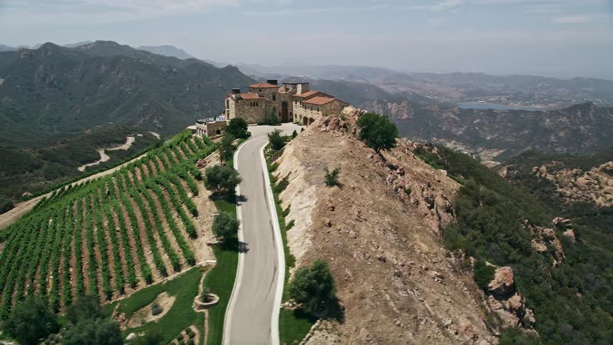 An aerial view of Malibus Rocky Oaks Estate Vineyards and rows of hillside vines on a mountaintop near Los Angeles