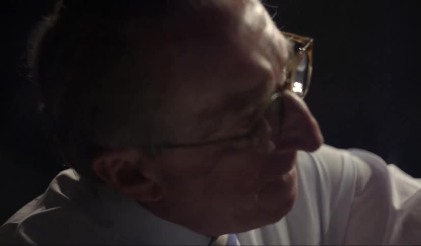 A man reaches out to something in front of him