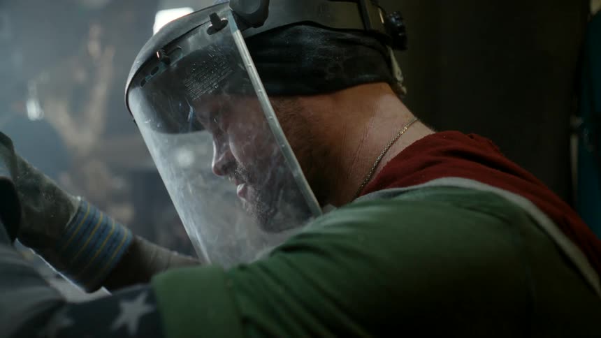 A man with a shield covering his face concentrates as he welds