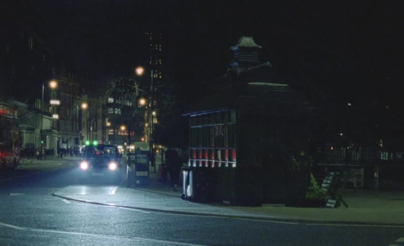A vehicle parks along a busy London intersection