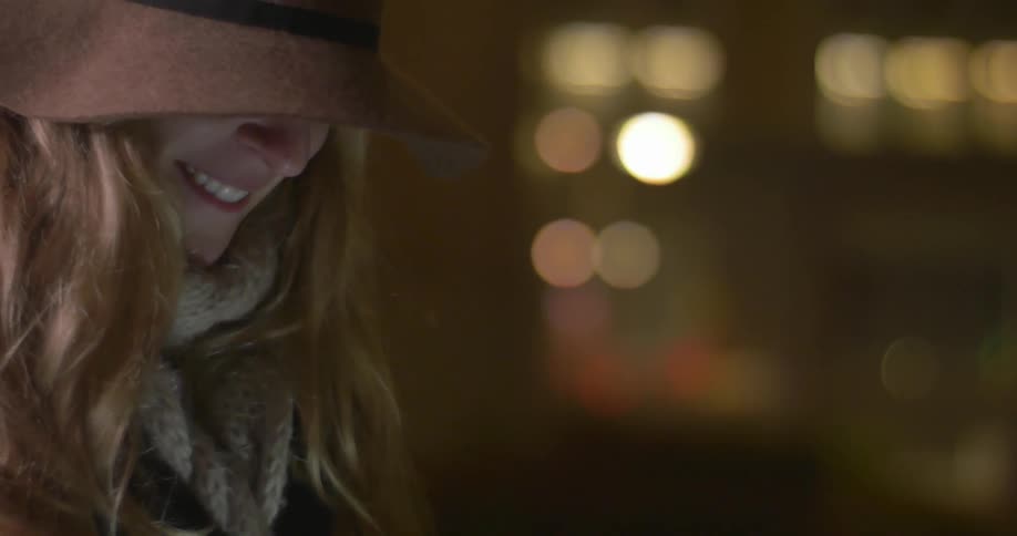 A woman smiling standing outside at night