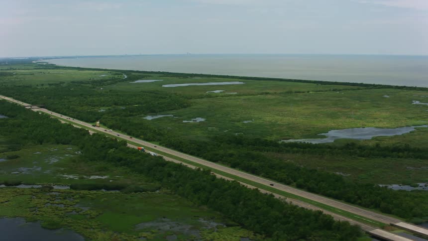 Aerial view of a road on the plains next to the ocean at daytime