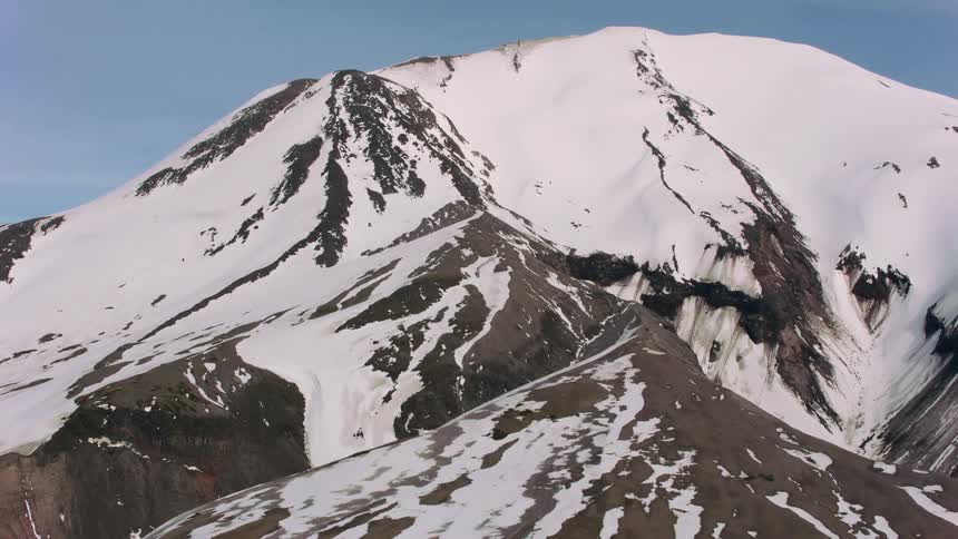 An aerial view of a snowcovered mountain peak
