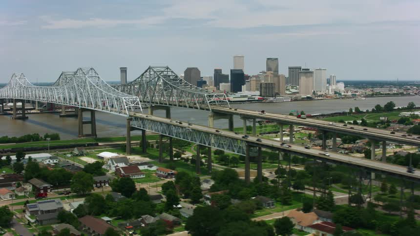 Drone view ofa city skyline and river separating the city and suburbia with a arch bridge connecting them