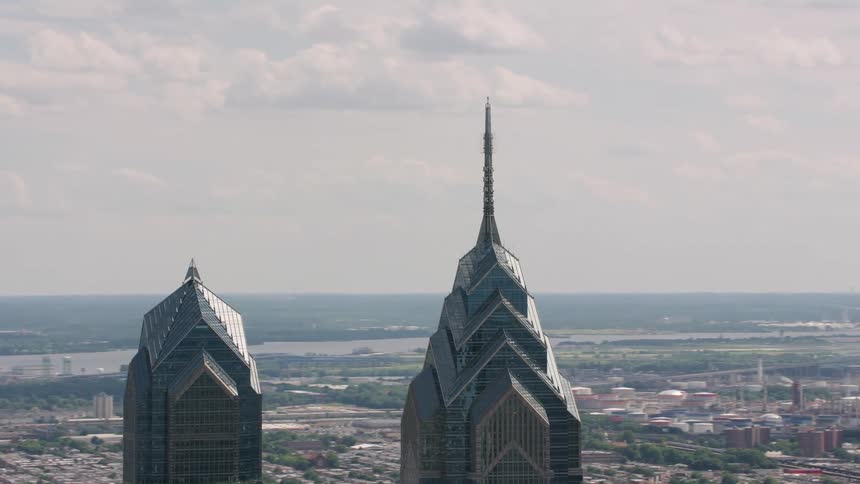 An aerial shot of tall glassy towers in an urban metropolis