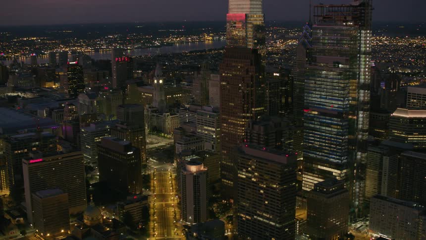 An aerial view of city towers lit up at night