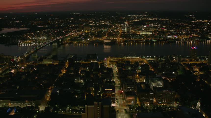 Aerial view of a river through an european city at night