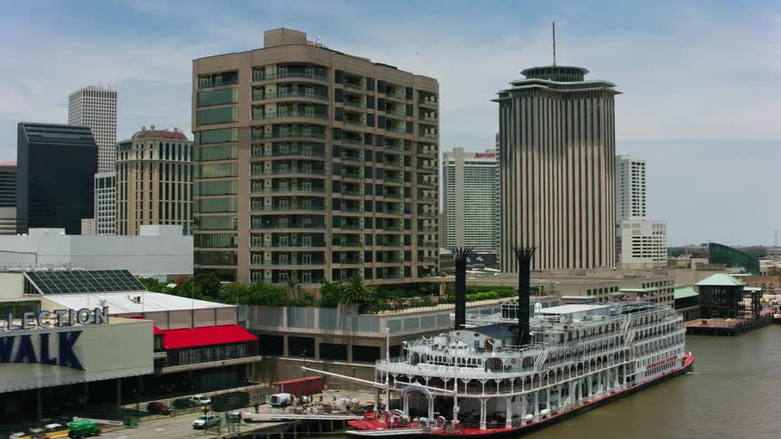 Aerial view of an oldtime boat docked in front of the city at daytime