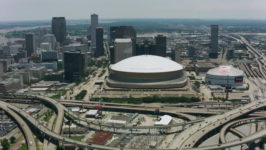 Highways split around stadiums on opposite side of city from river