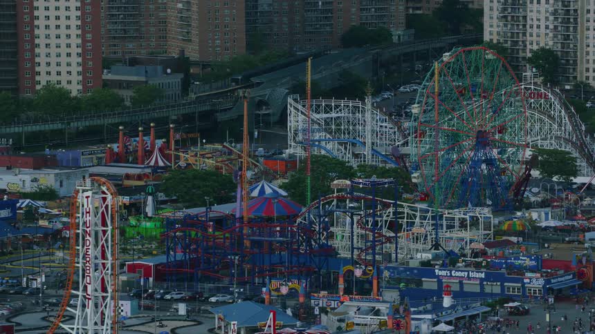 Aerial view of amusement park with ferris wheel and roller coaster