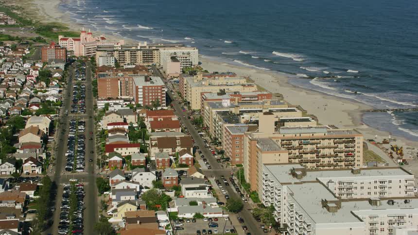Aerial view of sandy beach near the ocean and town
