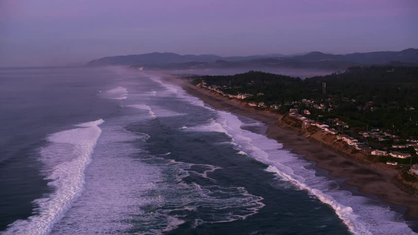Aerial view of the houses on the beach of a waterfront town at evening