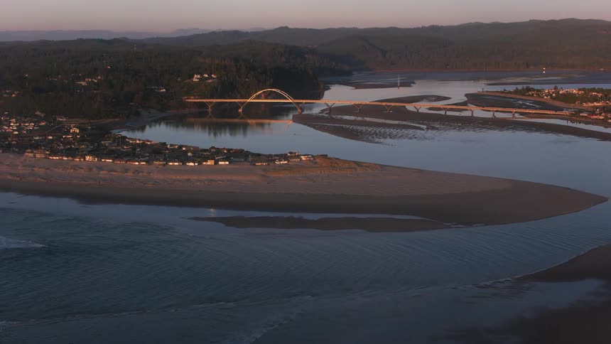 An aerial view of a river with a bridge on it