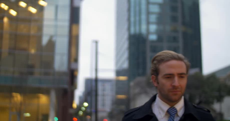 A man with a suit is walking in the city