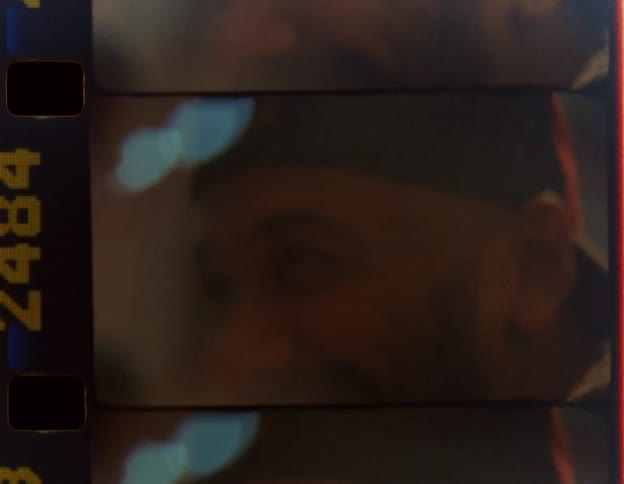 A man laughs while chatting with someone