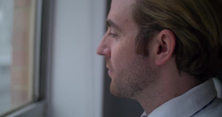 A man gazing through a window