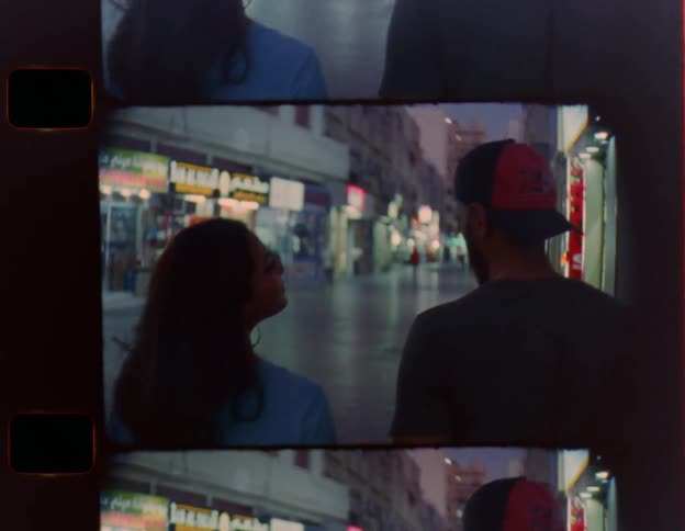 A couple joke around while walking downtown