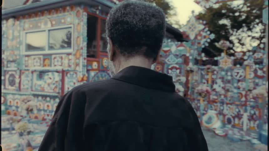 An elderly man is walking through a neighborhood