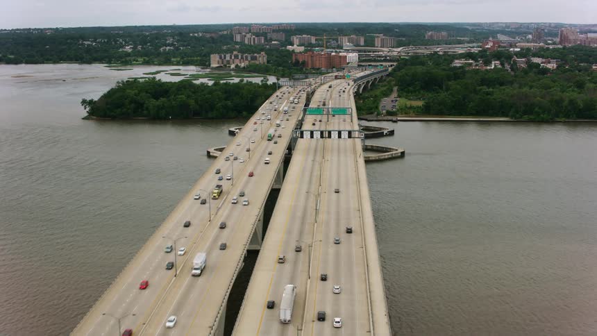 A highway bridge over a large body of water heading into a city