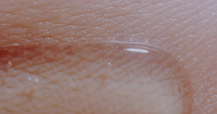 Oily liquid sliding slowly over human skin