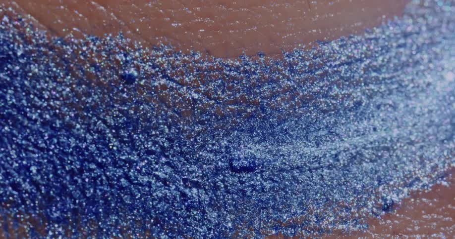Glitter being washed from human skin by water