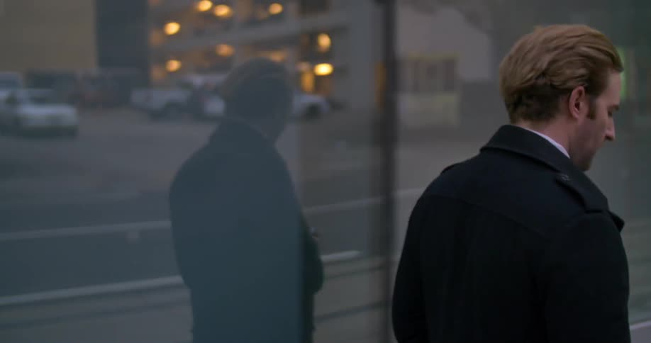 A man walking down a city sidewalk