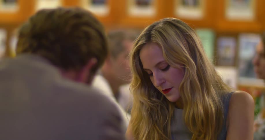 A man and woman sitting in a restaurant talking