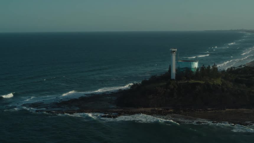 A peninsula with a modern tower surrounded by trees