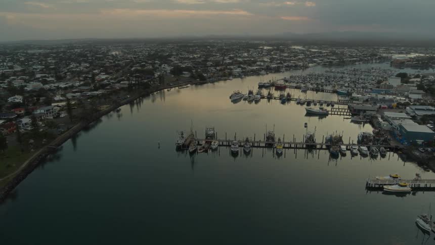 Aerial view of city and marina at dusk