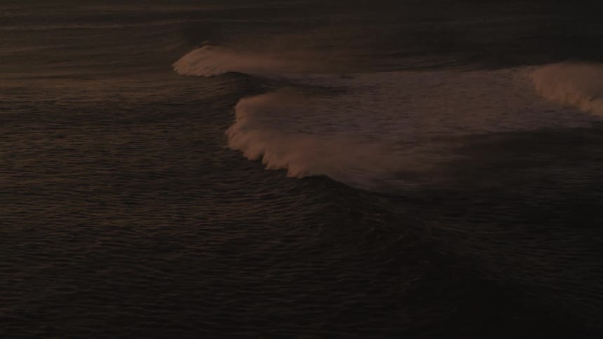 A large wave moves across the ocean